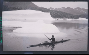 Image of Kayaker near small iceberg